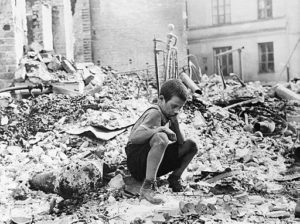 Polish boy in the ruins of the Warsaw, September 1939. Source, Julien Bryan captioned the photo in 1958: "A BOY'S WEARINESS--Ryszard Pajewski was a study in dejection when I saw him sitting on a pile of rubble. Only nine, he had suddenly been made the family breadwinner - and there was no bread to be had" 