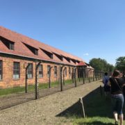 Electric fences, guard tower, and dorms at Auschwitz