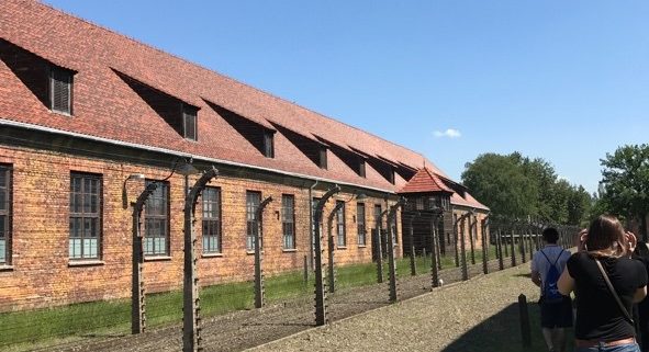 Electric fences, guard tower, and dorms at Auschwitz