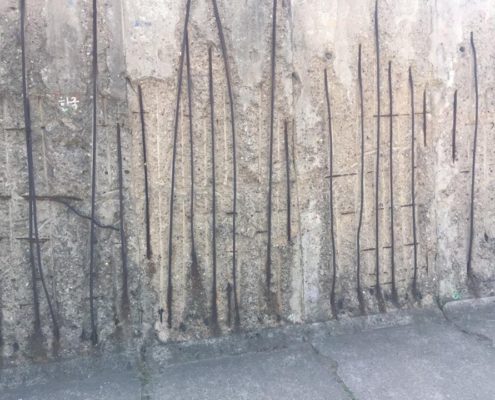 The cracks within the Berlin Wall.
