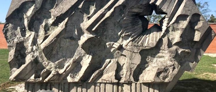 A large stone monument, depicting a line of soldiers in full charge. This piece perfectly reflects the style of rough stone texture, which recalls ancient art carvings.