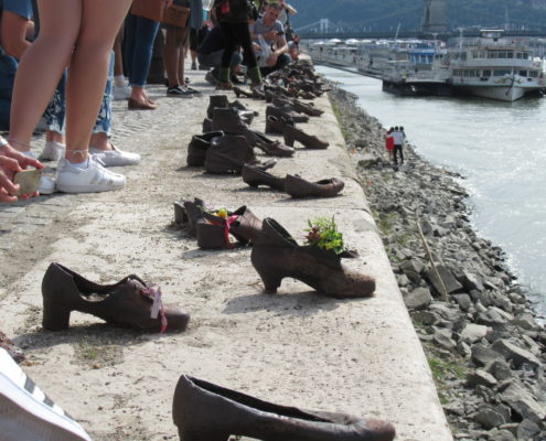 The Shoes on The Danube memorial in Budapest, marks a spot where thousands of Jews were shot into the Danube river.  This site is perhaps controversial for lacking descriptors, but it forces people to think about what had happened.