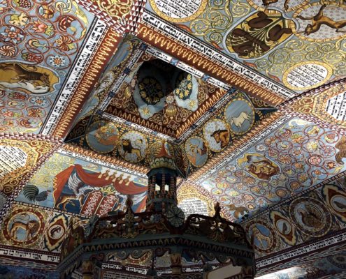 The replication of the ceiling of Gwoździec, a wooden synagogue in pre-war Poland. The exterior roof of the synagogue emerges from the first floor of the museum inside a glass casing.