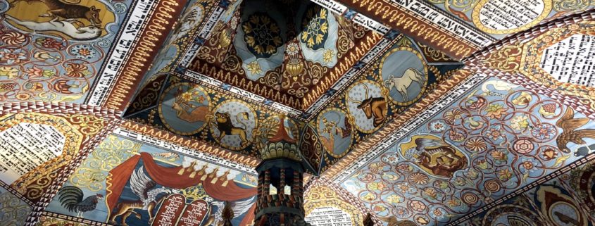 The replication of the ceiling of Gwoździec, a wooden synagogue in pre-war Poland. The exterior roof of the synagogue emerges from the first floor of the museum inside a glass casing.