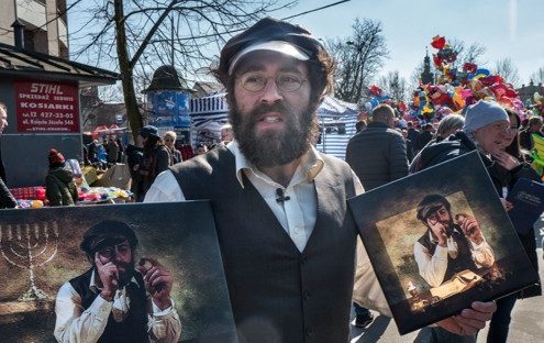 “Michael Rubenfeld selling his ‘lucky Jew’ portraits around Krakow. Photo credit FestivALT website httpswww.festivalt.comen-lucky-jew .”