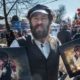 “Michael Rubenfeld selling his ‘lucky Jew’ portraits around Krakow. Photo credit FestivALT website httpswww.festivalt.comen-lucky-jew .”