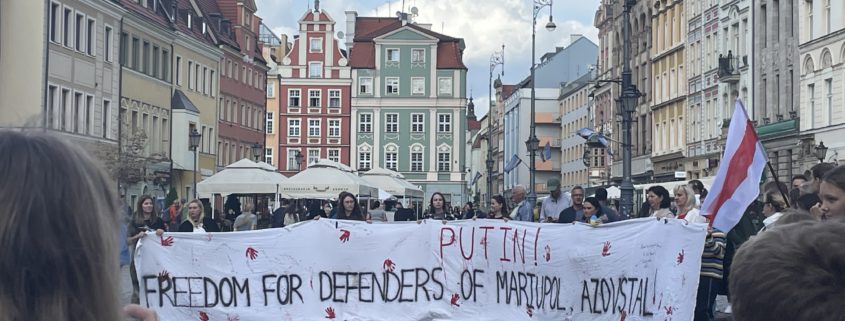 “Women stand in unity with Belarusians, protesting Putin’s invasion of Ukraine. Photo by Anna Meehan.