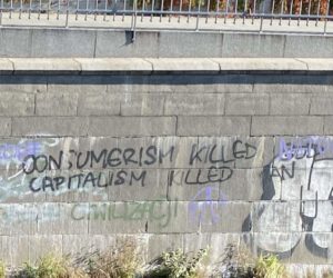 Consumerism Killed God (NATO written over), Capitalism Killed Man, in Wrocław, Poland. Photo By  Ian Eisenbrand.