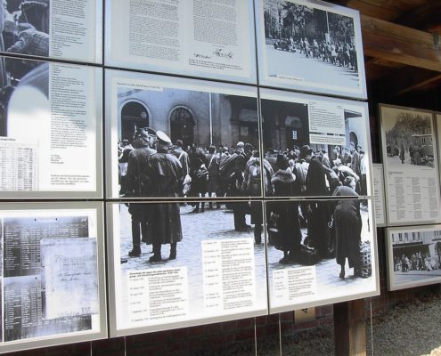 Image from the Topography of Terror Museum with a panel showing German Jews being deported to their deaths. Despite her insistence of being only an onlooker in the capturing of Jews, Stella Goldschlag was still responsible either directly or indirectly for hundreds of German Jews being sent to concentration camps and their eventual deaths. Photo credit: Public domain image by Adam Carr, posted on Wikipedia